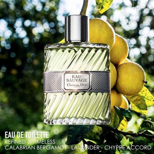 Dior Eau Sauvage perfume bottle with lemons on a blurred green background