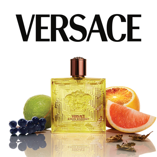 Versace perfume bottle with fruit slices and leaves on a white background